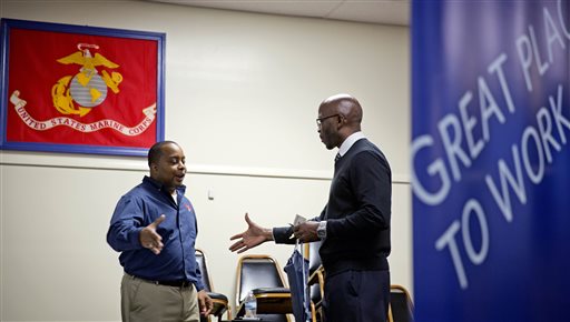 In this Thursday, Nov. 14, 2013, file photo, retired U.S. Army Sgt. 1st Class Duane Stubbs, right, of Morrow, Ga., shakes hands with retired U.S. Army 1st Sgt. Leland Smith, CEO of SolidHires, during a job fair for veterans at the VFW Post 2681, in Marietta, Ga. The Labor Department reports on the number of Americans who applied for unemployment benefits last week on Wednesday, Nov. 27, 2013. (AP Photo/David Goldman, File)