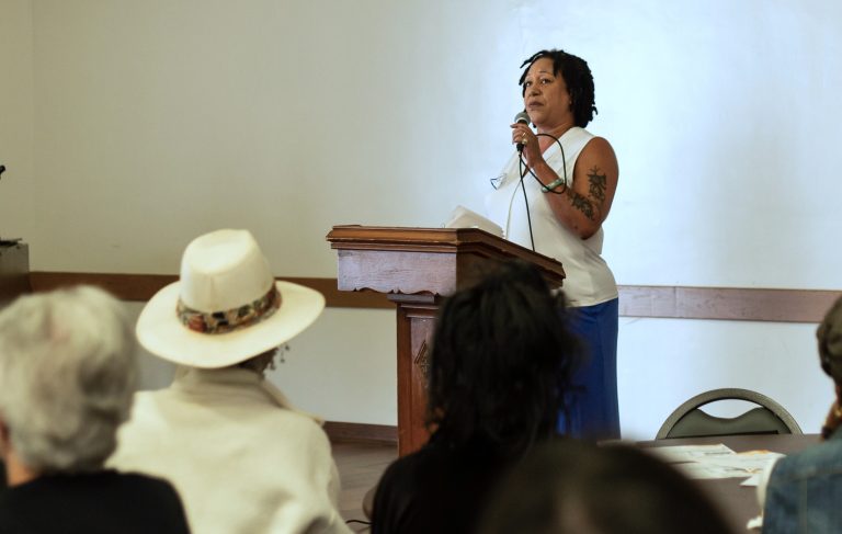 Cat Brooks speaks to the crowd at Taylor Memorial United Methodist Church in West Oakland. (Photo by: Saskia Hatvany)