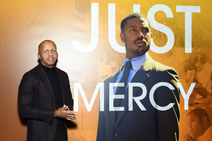 Lawyer and criminal justice and prison reform advocate and author on whom the film was based, Bryan Stevenson in front of the ‘Just Mercy’ poster.