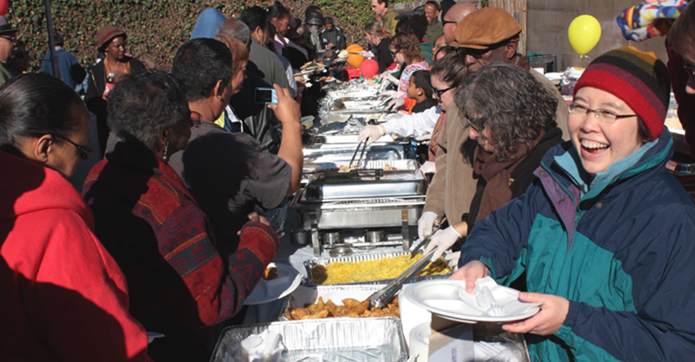 Community residents (left) and volunteers (right) participating in Two Star Market's Annual Thanksgiving Community Celebration last year. Photo courtesy of Two Star Market.