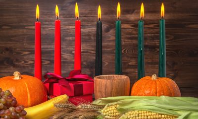 A typical Kwanzaa altar features a mat, fruits and vegetables as well as a kinara, or candleholder and mishumaa saba, the seven candles representing the principles of Kwanzaa that are lit each day from December 26 to January 1. Photo courtesy of iStock.