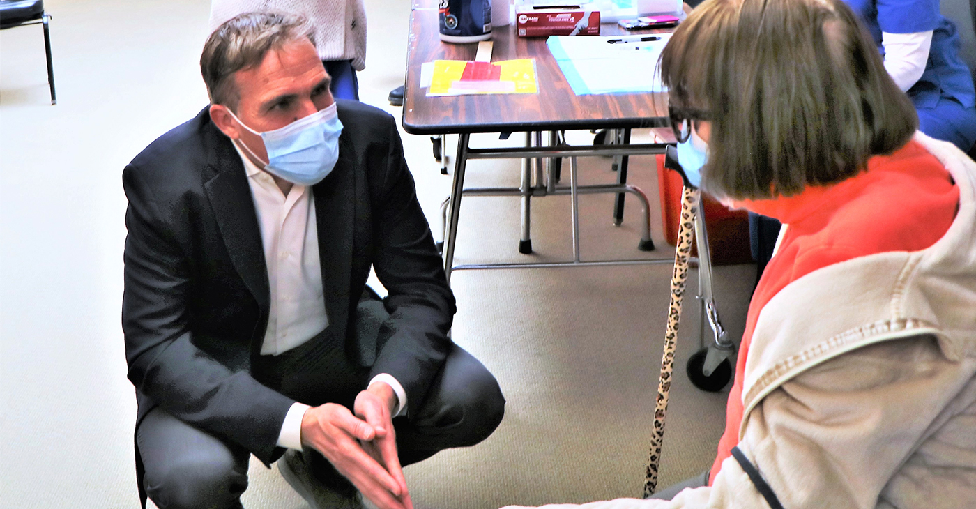 Dr. Matt Willis, Marin County Public Health Officer, speaks with a woman at a COVID-19 vaccination clinic earlier this year.