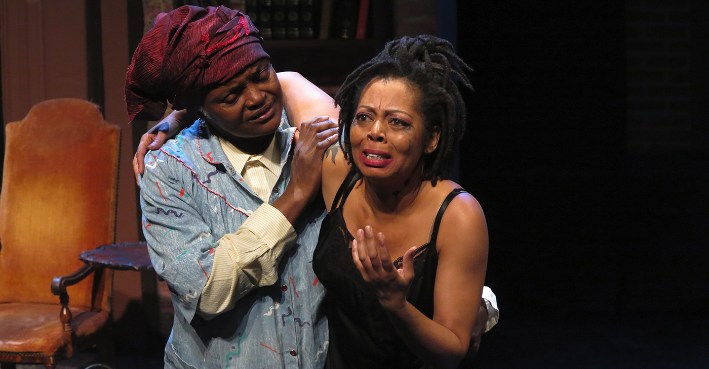 Detective Mary van Helsing (Roz Fox), left, rescues Jennifer Blue (Kenya Wilson), one of the victims in the continuing exploitation of Blackness. Photo by Jonathan Slaff.