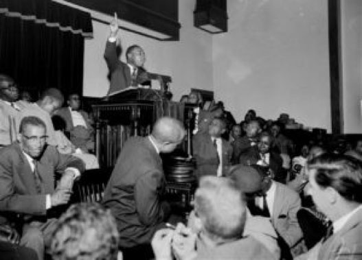 Martin Luther King speaks to an overflow crowd at a mass meeting at Holt Street Baptist Church in Memphis. (AP Photo/Gene Herrick)