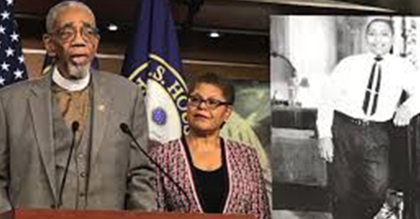 Rep. Bobby Rush, who represents the Chicago district where Emmett Till lived, and Los Angeles Rep. Karen Bass with a photo of Emmett Till speaking before the House passed the bill last month. Photo courtesy of Rush press office.