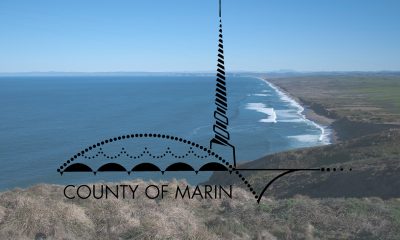 The California County of Marin logo on a Feb. 8, 2016 photo of the Point Reyes Beach and the Pacific Ocean. (Photo courtesy Marin County/NPS/Greg Purifoy)