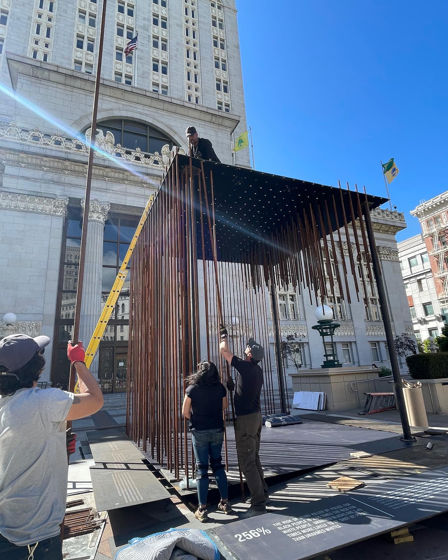 Support Oakland Artists Executive Director Randolph Belle atop the installation called 'Society's Cage' as it was being assembled.  Photo courtesy of Facebook.