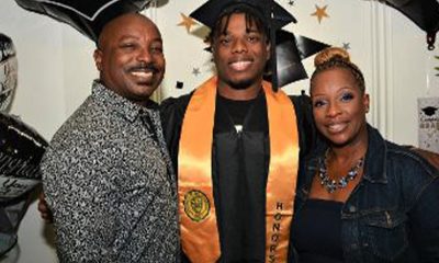 Isaiah Saucer, in cap and gown, is flanked by his father Marvin Saucer, left, and his mother, Altrinice Grant Saucer, right. Photo by Joe L. Fisher.