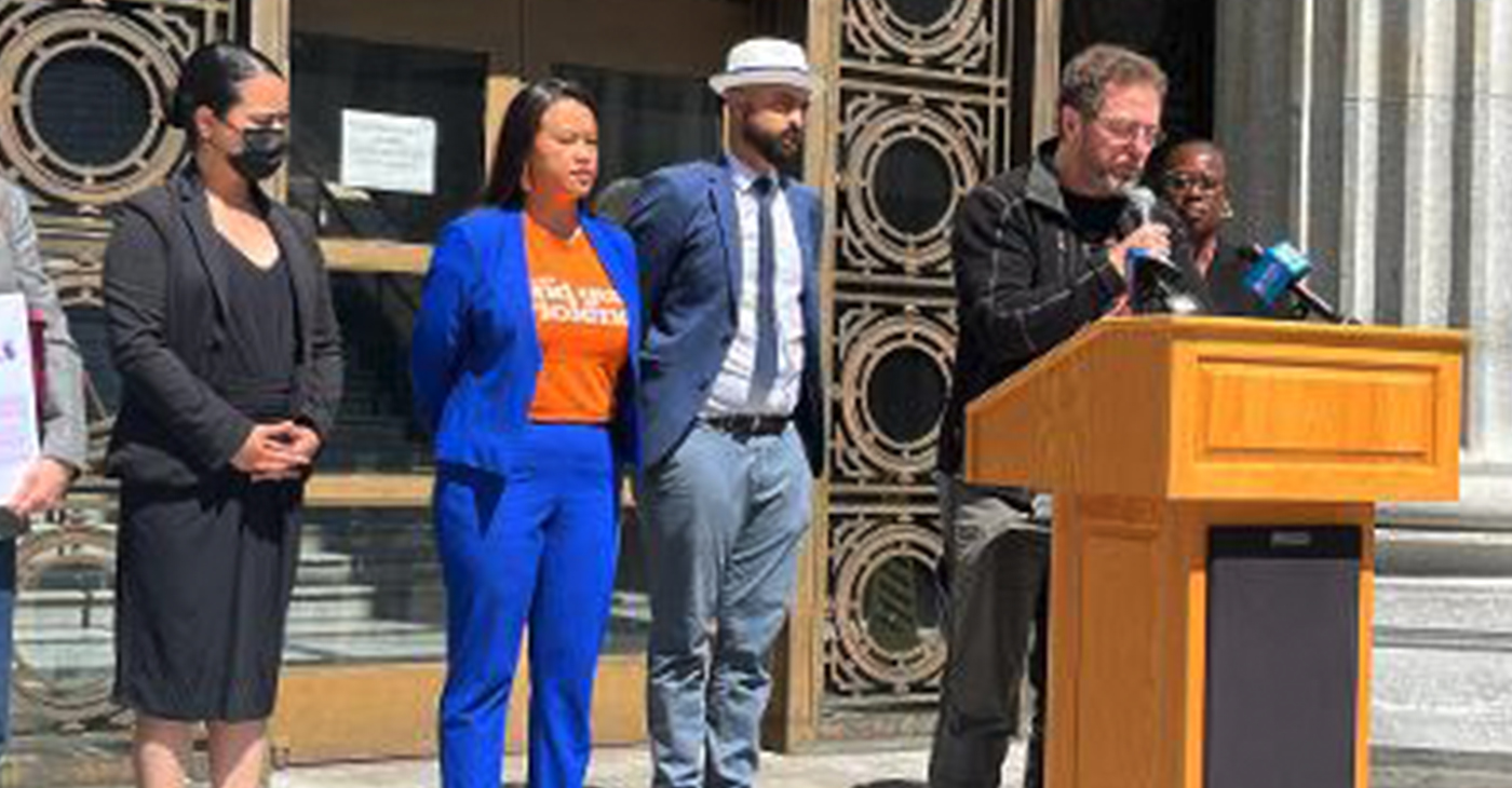 Speaking in front of Oakland City Hall at a press conference to save Mills College on Tuesday, July 19, 2022, were: Claudia Mercado, Mills Alumnae; Council President Pro Tempore Sheng Thao; Brandon Harami, Sheng Thao's council aide; Kieran Turan, vice president of Save Mills Coalition; and Kimberly Jones, Kaplan's chief of staff. Photo by Ken Epstein.