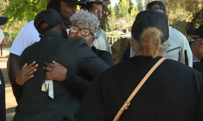 People comfort each other in the wake of the school shooting Wednesday afternoon on the King Estates complex in East Oakland. Photo courtesy of KTVU2.