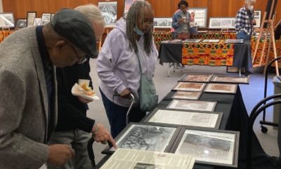 (Left) Bertram Clark, U.S. Navy Vietnam-era veteran, and curator of the African Americans in the Military During WWII Exhibit, examines a display at the San Leandro Main Library. / Photo credit: Conway Jones