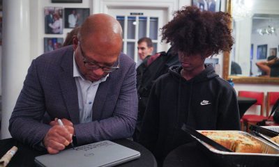 Broderick Johnson (left) inscribes the laptop for one of the members of the Hidden Genius Project. (Photo courtesy of The Hidden Genius Project.)