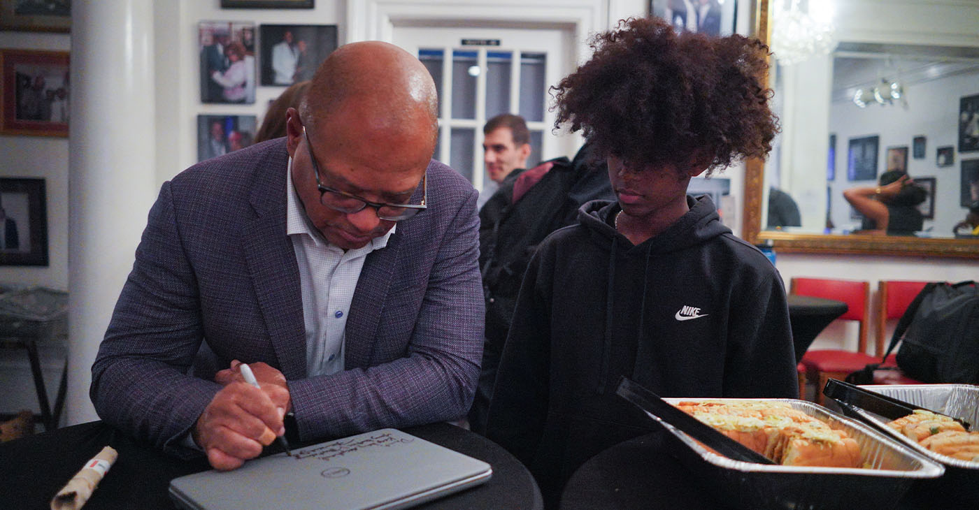 Broderick Johnson (left) inscribes the laptop for one of the members of the Hidden Genius Project. (Photo courtesy of The Hidden Genius Project.)