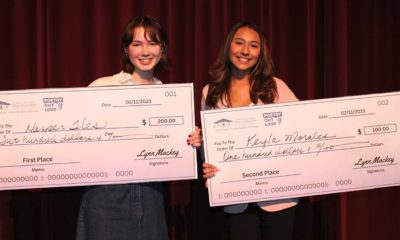 Harper Iles, left, and Kayla Morales each hold the scholarship checks they received for winning in the Poetry Out Loud competition on Feb. 11. Photo courtesy of Contra Costa County Office of Education.