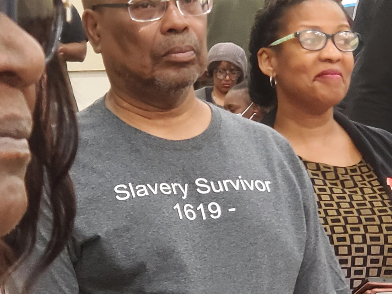 A participant stands and waits to give public comment at the March 4  Reparations Task Force  meeting in Sacramento. CBM photo by Antonio Ray Harvey.