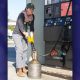 Johanna Good, an inspector with Agriculture / Weights & Measures, checks volume accuracy at a service station pump.