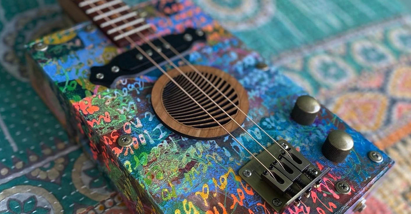 Steve Zwetsch of Cigar Box Kitchen Guitars will sell art collaborations such as this one for a good cause at the Spring Fling & Art Stroll. (Photo contributed)