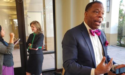 Tax attorneys Raymond Brown and Sarah Moore-Johnson (center, talking to a reporter) testified at the last Reparations Task Force Meeting in San Diego on Jan. 28, 2023. The attorneys said reparations could be funded through a state estate tax. Photo by Antonio Ray Harvey.