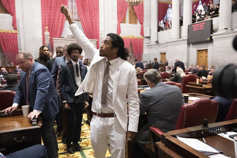 Former Rep. Justin Jones, D-Nashville, raises his fist on the floor of the House chamber as he walks to his desk to collect his belongings after being expelled from the legislature on Thursday, April 6, 2023, in Nashville, Tenn. Tennessee Republicans are seeking to oust three House Democrats including Jones for using a bullhorn to shout support for pro-gun control protesters in the House chamber. (AP Photo/George Walker IV)