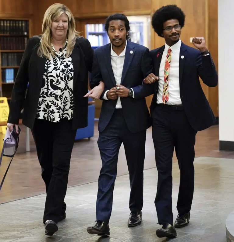 From left, expelled Rep. Justin Pearson, D-Memphis, Rep. Gloria Johnson, D-Knoxville, and expelled Rep. Justin Jones, D-Nashville raise their fists as they walk across Fisk University campus after hearing Vice President Kamala Harris speak, Friday, April 7, 2023, in Nashville, Tenn. (AP Photo/George Walker IV)