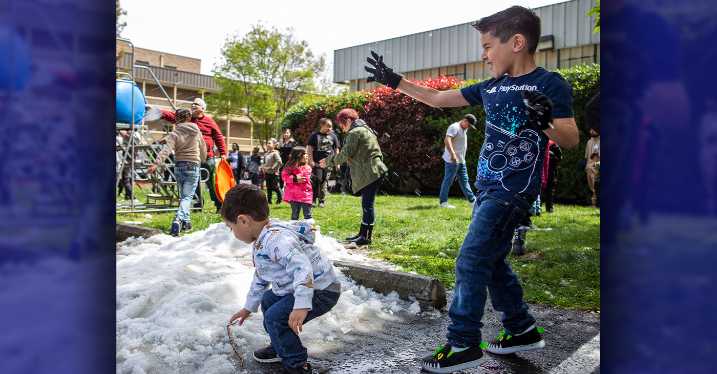 From left, Ryland Cordova, 2, and Aiden Cordova, 6, play in the snow during Snow Day at Quail Lakes Baptist Church in Stockton, Calif., on April 8, 2023. (Harika Maddala/Bay City News/Catchlight Local)