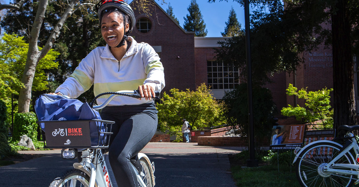 Olivia Mitchell returns after riding an e-bike across the campus during Rise ‘N’ Ride at University of the Pacific in Stockton, Calif., on April 1, 2023. (Harika Maddala/Bay City News/Catchlight Local)