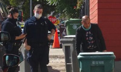Oakland Police Investigator Phong Tran (right) at the scene of a 2020 homicide. Photo courtesy Darwin BondGraham/Oaklandside.