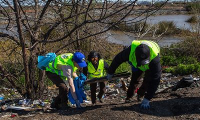 Volunteers from California Conservation Corps move tram up the slope during community cleanup event at Roberts Island in San Joaquin County, Calif., on March 25, 2023. (Harika Maddala/Bay City News/Catchlight Local)