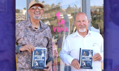 “Remember Their Sacrifice” authors Arif Khatib, left, and Pete Elman pose with copies of their book in front of YEMA in Tiburon. Photo by Godfrey Lee.