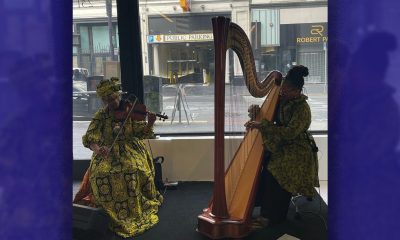 Violinist Tarika Lewis, left, and Harpist Destiny Muhammad, both of Oakland performed at the Fourth Annual The Black Woman Is God opening reception on June 29. Photo by Zoe Jung.