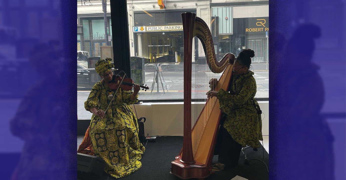 Violinist Tarika Lewis, left, and Harpist Destiny Muhammad, both of Oakland performed at the Fourth Annual The Black Woman Is God opening reception on June 29. Photo by Zoe Jung.