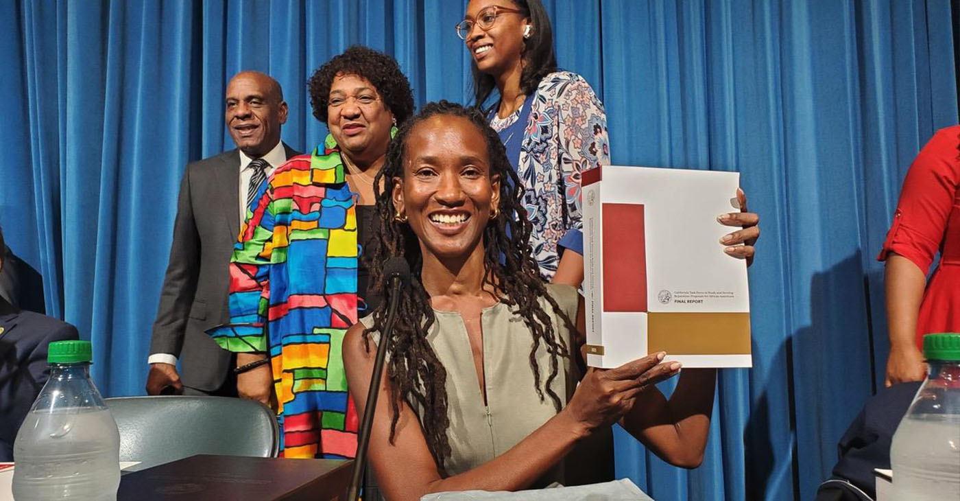 Lisa Holder, Oakland-based attorney and member of the California Reparations Task Force, holds up the 1075-page final report. The nine-member panel submitted 115 recommendations to the California Legislature two days before the June 30 deadline. CBM photo by Antonio Ray Harvey.