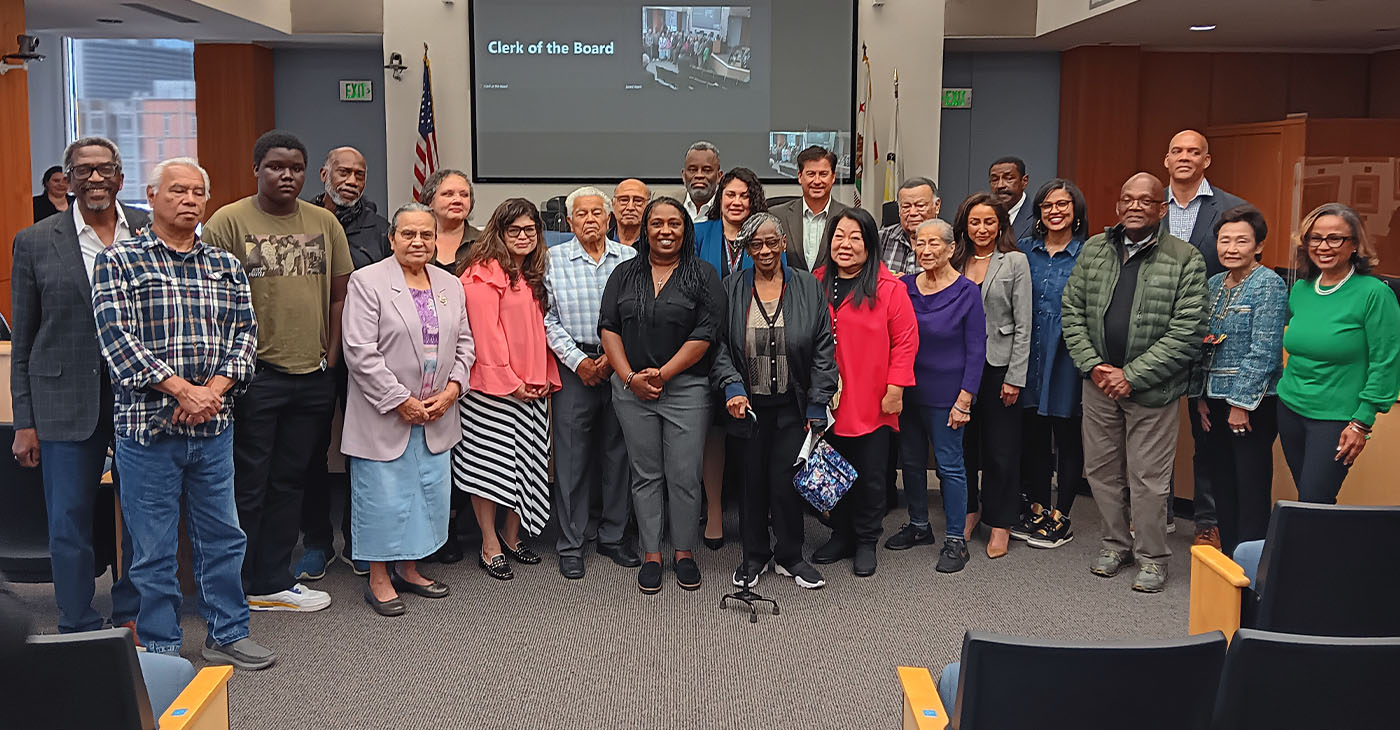 Citizens who came to witness reading of resolution apologizing for seizure of Russell City pose for a photo with Supervisor Nate Miley, far left, and Aisha Knowles, far right, who has been spearheading the effort. Photo by Erika Brink.