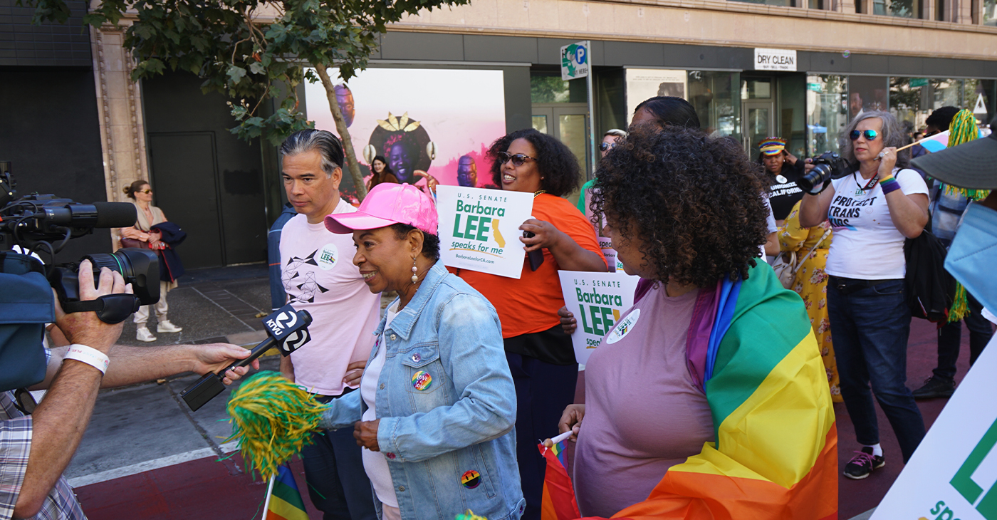 Congresswoman Barbara Lee, wearing a pink hat, and California Attorney General Rob Bonta lead the Oakland Pride Parade. Photo by Gene Hazzard.