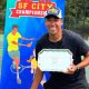 Fernando Ramos, a physical education teacher in Richmond, holds his prize after winning the San Francisco City Championships NTRP Gold Cup series tournament. Photo courtesy The Richmond Standard.