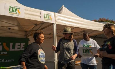 Wearing a sweatshirt honoring her mentor, the late Shirley Chisholm, U.S. Senate Candidate Barbara Lee engages with Taste of Soul attendees at her booth on Sunday. Photo by Maxim Elramsisy, California Black Media.