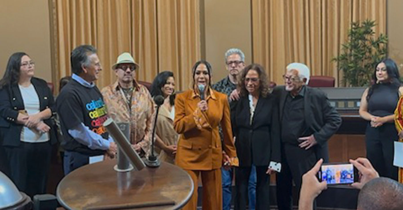 Sheila E., center, speaks at the award ceremony in council chambers as her white-haired father, Pete Escovedo, right, and Gallo, second from left, listen. Photo courtesy of the office of Councilman Noel Gallo. KTVU news contributed to this report.
