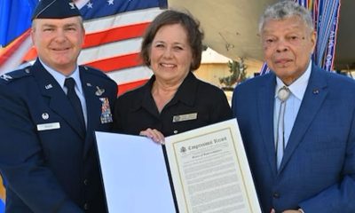 Colonel Terence McGee, 349th Air Mobility Wing commander, Lois Cross, Senior District Representative for Representative John Garamendi, and Conway Jones, Colonel, USAF (Retired), a 349th Air Mobility Wing alum, pose with a Congressional Record, published by Congressman John Garamendi (CA-8), honoring the 80th anniversary of the 349th Air Mobility Wing, Travis Air Force Base, California, Oct.14, 2023. Photograph courtesy 349th Air Mobility Wing