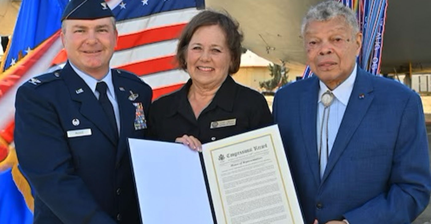 Colonel Terence McGee, 349th Air Mobility Wing commander, Lois Cross, Senior District Representative for Representative John Garamendi, and Conway Jones, Colonel, USAF (Retired), a 349th Air Mobility Wing alum, pose with a Congressional Record, published by Congressman John Garamendi (CA-8), honoring the 80th anniversary of the 349th Air Mobility Wing, Travis Air Force Base, California, Oct.14, 2023. Photograph courtesy 349th Air Mobility Wing