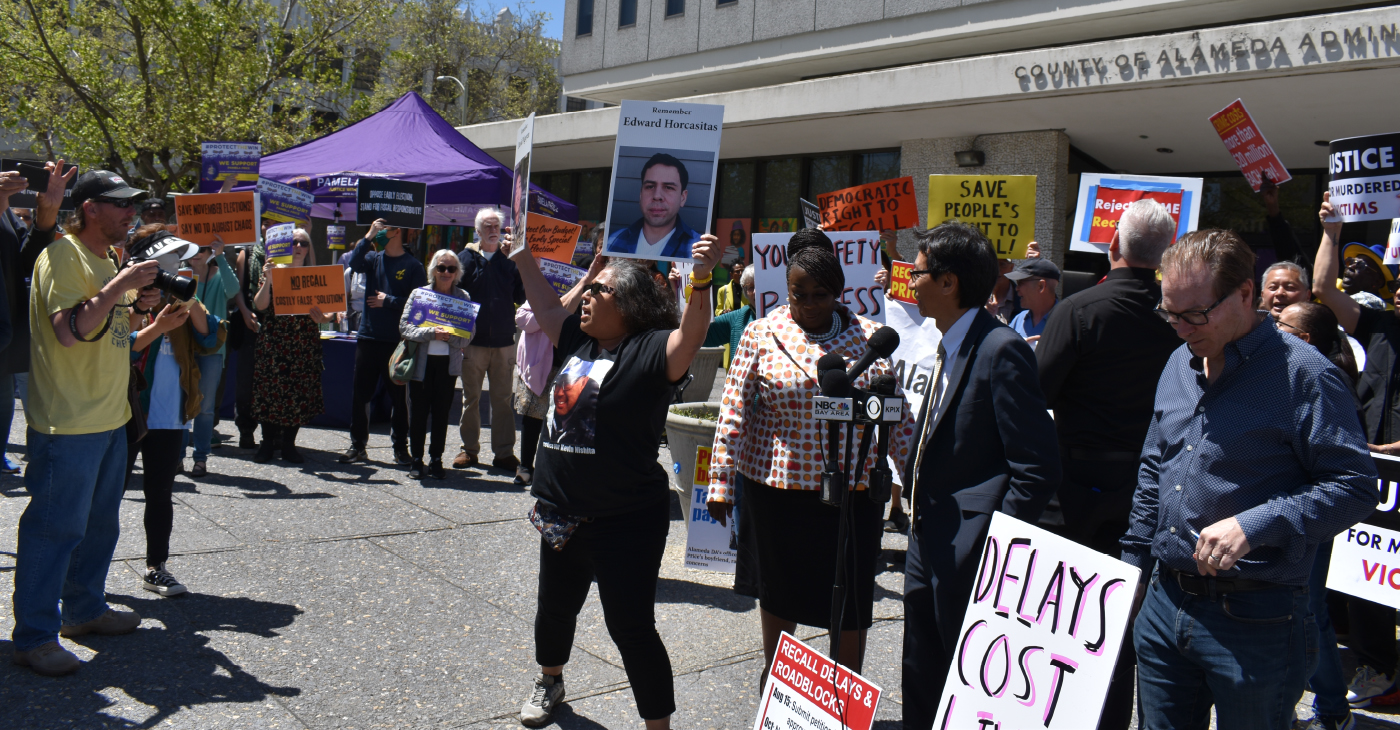 District Attorney Pamela Price ‘Protect the Win’ supporters held signs outside of the County Administration Office to ask the Board of Supervisors to not schedule a special recall election. Photo by Magaly Muñoz.