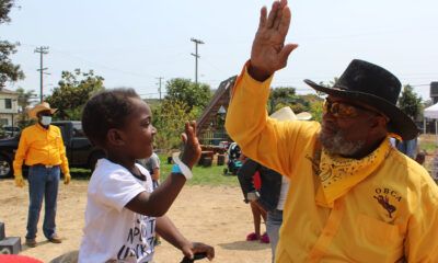 The Oakland Black Cowboys Association will hold an event to teach children the love of riding at Fairyland on Feb. 14. Here, a member of the OBCA high-fives a young rider at an event in 2021. Facebook photo.