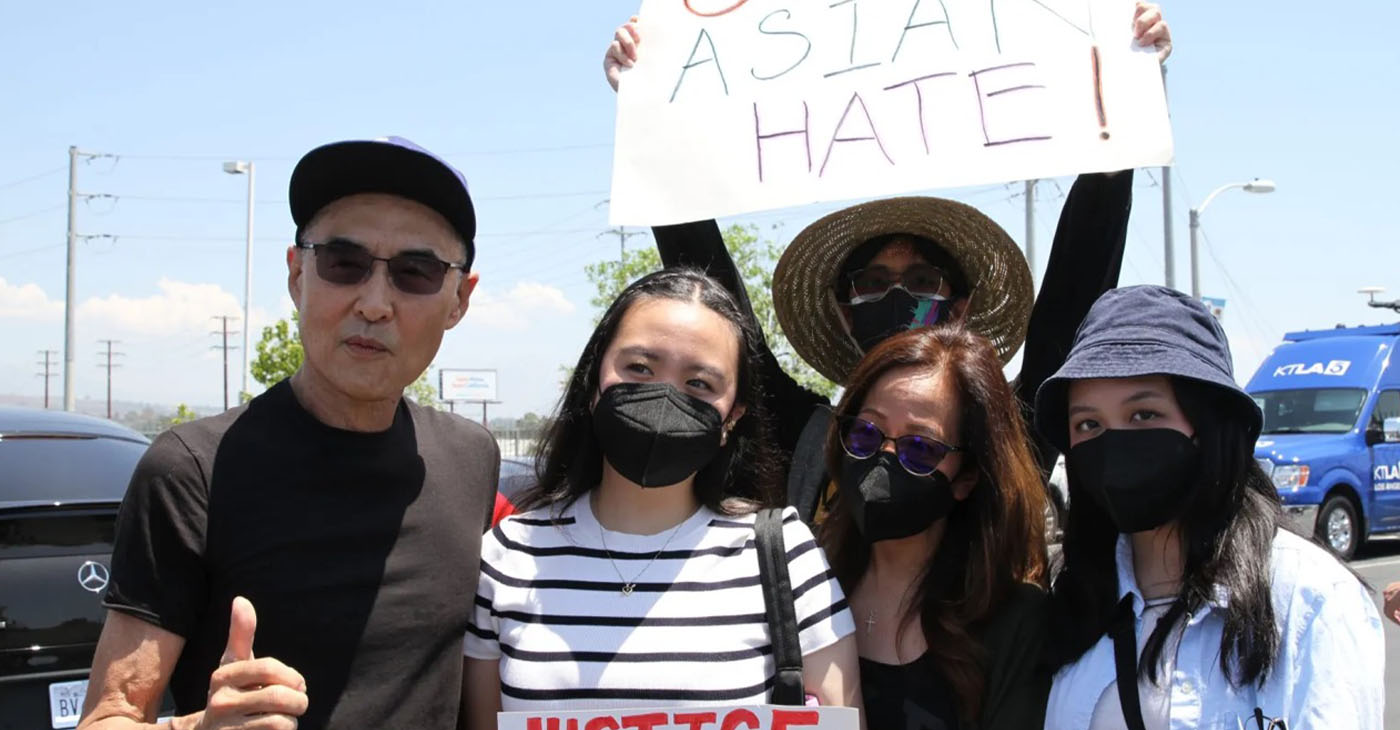 Patricia Roque (far right) pictured with her family at a Stop Asian Hate rally after her father's assault (far left). (Courtesy of AAPI Equity Alliance)
