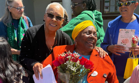 Cassandra Lopez, known as “Mama C,” is surrounded by family, friends, and neighbors at Oakland’s annual Mother of Year celebration at the Morcom Rose Garden, Saturday, May 9. Photo by Mateenah Floyd-Okanlawon.