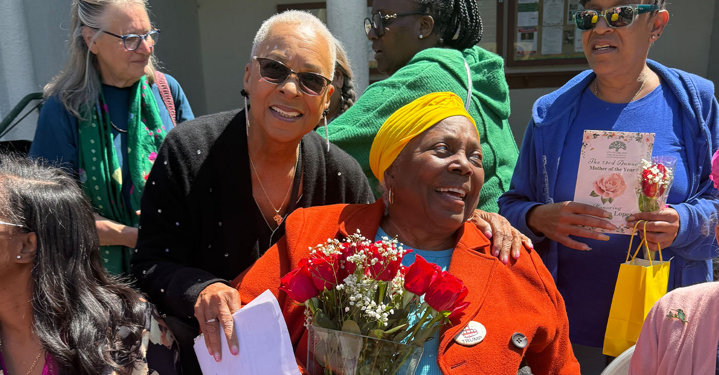 Cassandra Lopez, known as “Mama C,” is surrounded by family, friends, and neighbors at Oakland’s annual Mother of Year celebration at the Morcom Rose Garden, Saturday, May 9. Photo by Mateenah Floyd-Okanlawon.