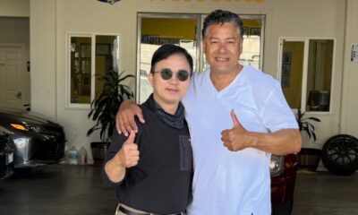 Enoch Shin, left, operator of an auto body shop on International Boulevard in Oakland, with City Councilmember Ken Houston, right, at the Oakland City Council meeting on Tuesday.