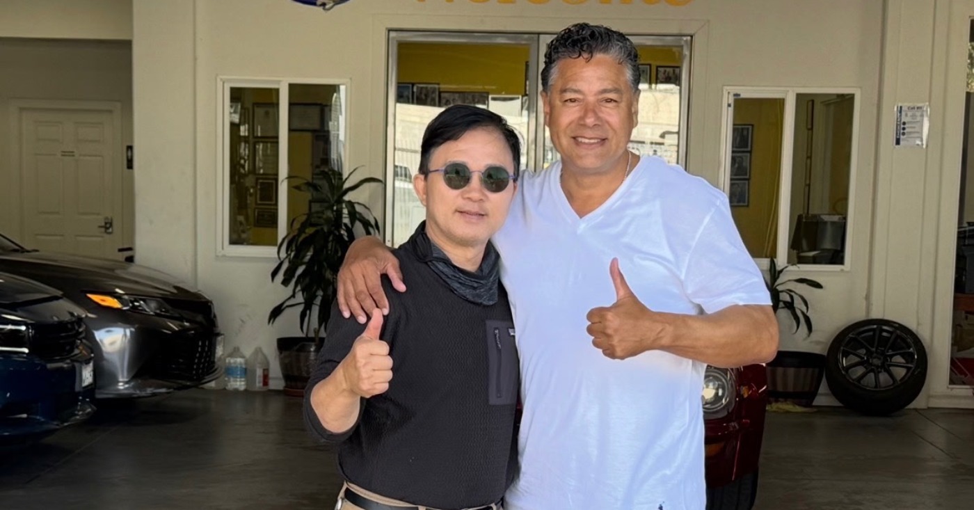 Enoch Shin, left, operator of an auto body shop on International Boulevard in Oakland, with City Councilmember Ken Houston, right, at the Oakland City Council meeting on Tuesday.