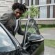 Man entering car with open car door.