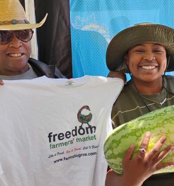 Elaine Smith, executive director of Farms to Grow, Inc., holds T-shirt for Ki’Ara LaFitte, winner of the Freedom Farmers’ Market Watermelon-Eating Contest at the season opening on July 11. Courtesy photo.