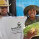 Elaine Smith, executive director of Farms to Grow, Inc., holds T-shirt for Ki’Ara LaFitte, winner of the Freedom Farmers’ Market Watermelon-Eating Contest at the season opening on July 11. Courtesy photo.