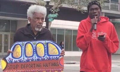 Activists Gerald Smith and Romaine Charite at 14th and Broadway in downtown Oakland near City Hall protest in support of Haitian immigrant rights. Photo by Carla Thomas